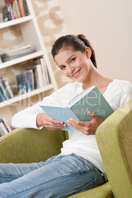 Students - Happy teenager with book sitting on armchair