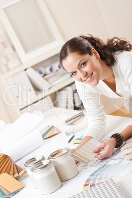 Young female interior designer at office with paint