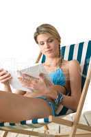 Beach - Happy young woman with book in bikini