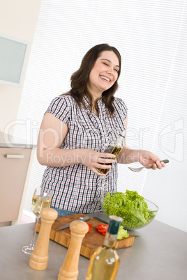 Cook - Plus size happy woman preparing vegetable salad