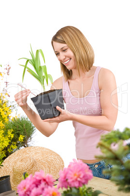 Gardening - Smiling woman holding flower pot