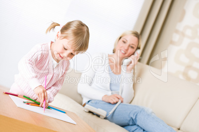 Little girl draw with color pencil in lounge