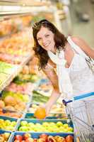 Grocery store - smiling woman shopping choose fruit
