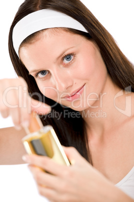 Beautiful woman holding perfume