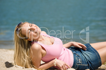 Blond woman enjoy summer sun on beach