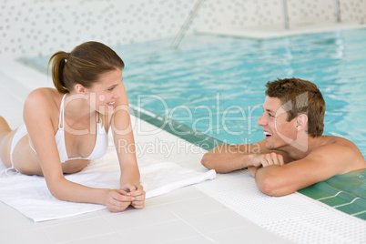 Swimming pool - young happy couple relax
