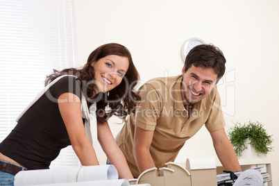 Smiling man and woman working