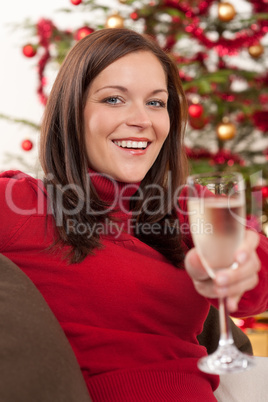 Attractive brown hair woman in front of Christmas tree