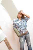 Home improvement: Young woman with paint roller