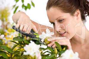 Gardening - woman cutting flower with pruning shears