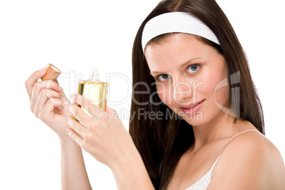 Beautiful woman holding perfume