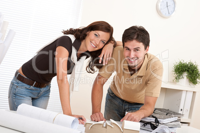 Smiling man and woman working