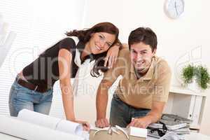 Smiling man and woman working