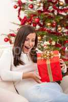 Surprised woman with Christmas gift