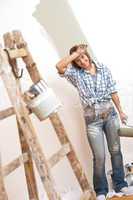 Home improvement: Cheerful woman with paint roller