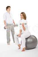 Fitness - Young couple exercise with weights and ball