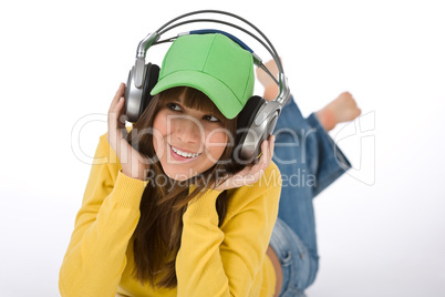 Happy female teenager enjoy music with headphones