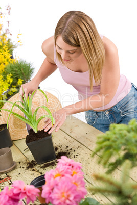 Gardening - woman with shovel take care of plant