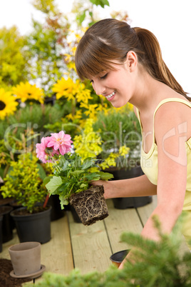 Gardening - smiling woman holding flower pot