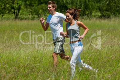 Young couple jogging outdoors in spring nature