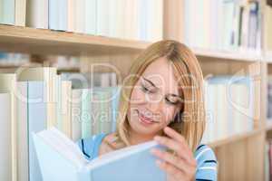 Student in library - happy woman study book