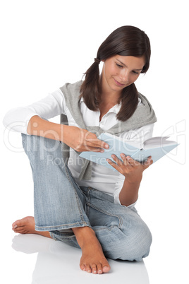 Teenager holding book and reading