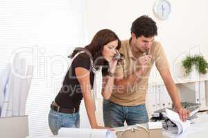 Young man and woman working at architect office