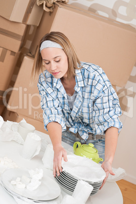 Moving house: Woman unpacking box