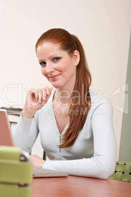 Long red hair  business woman with laptop