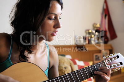 Young woman playing guitar