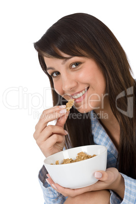 Smiling woman eat healthy cereal for breakfast