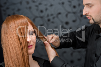 Professional hairdresser with fashion model at luxury salon