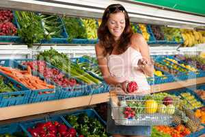 Grocery store shopping - Smiling woman with vegetable