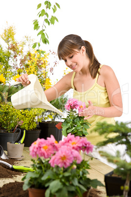 Gardening - woman with watering can and flowers