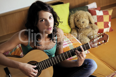 Young woman playing guitar