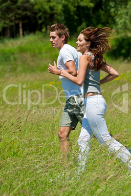 Young couple jogging outdoors in spring nature