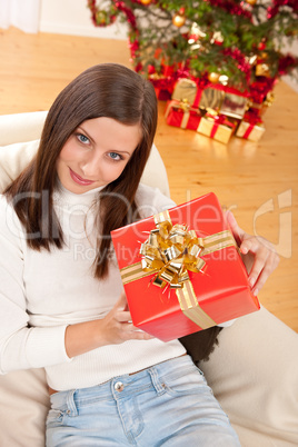 Young woman holding Christmas present