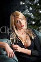 Portrait of blond sexy woman with champagne on Christmas