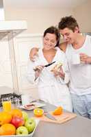 Happy couple having breakfast in the kitchen