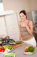 Smiling young woman in the kitchen