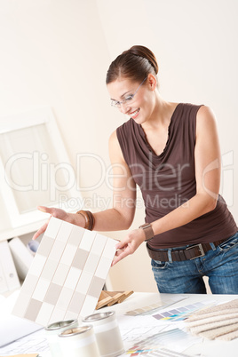 Female interior designer working with color swatch