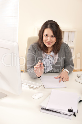 Young business woman working at office