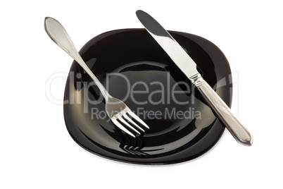 Black plate with fork and knife