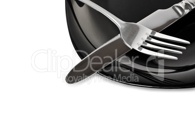 Black plate with fork and knife