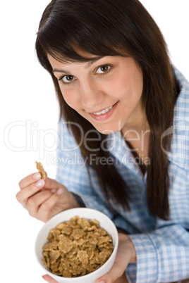 Smiling woman eat healthy cereal for breakfast