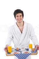 Breakfast - young man holding tray with breakfast