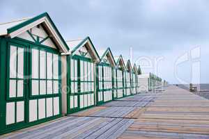 Long row of wooden beach cabins