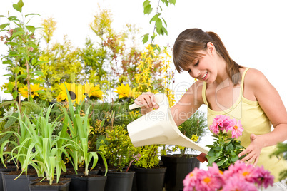 Gardening - woman with watering can and flowers pouring water