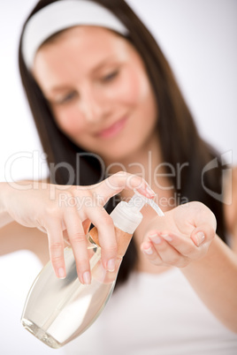 Body care - woman applying massage oil