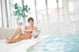 Swimming pool - woman relax with book